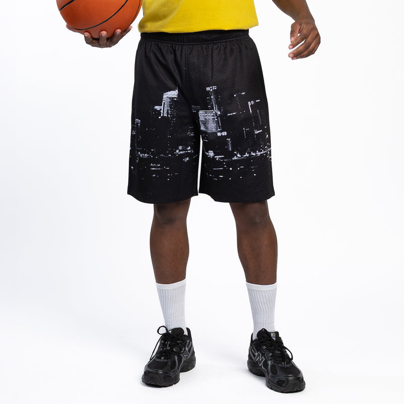 Men's black mesh skyline print shorts with elastic waist; shown from back with socks