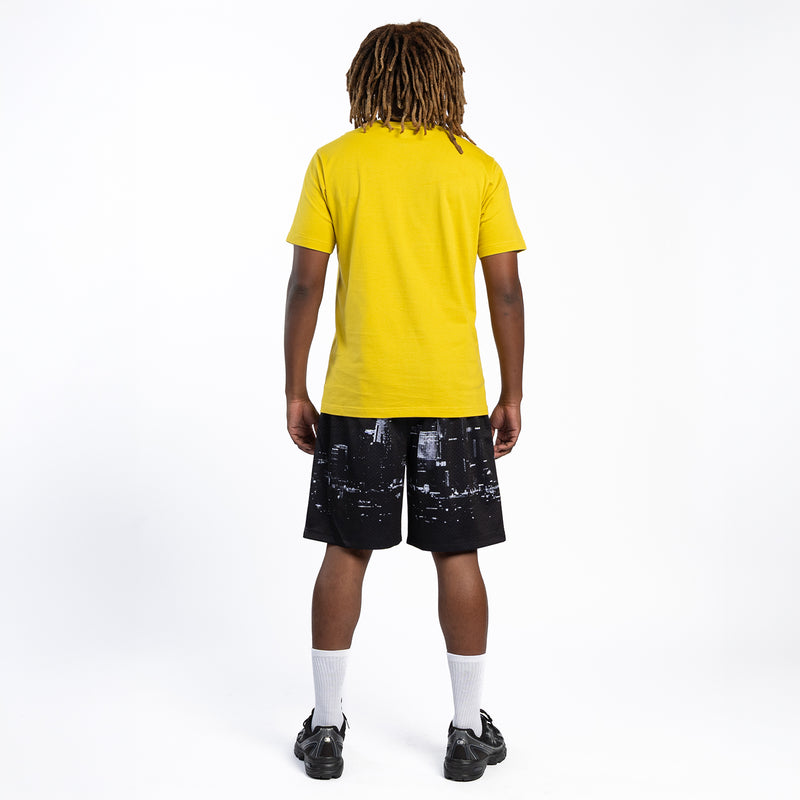 Men's black mesh skyline print shorts; back view with yellow T-shirt and sneakers