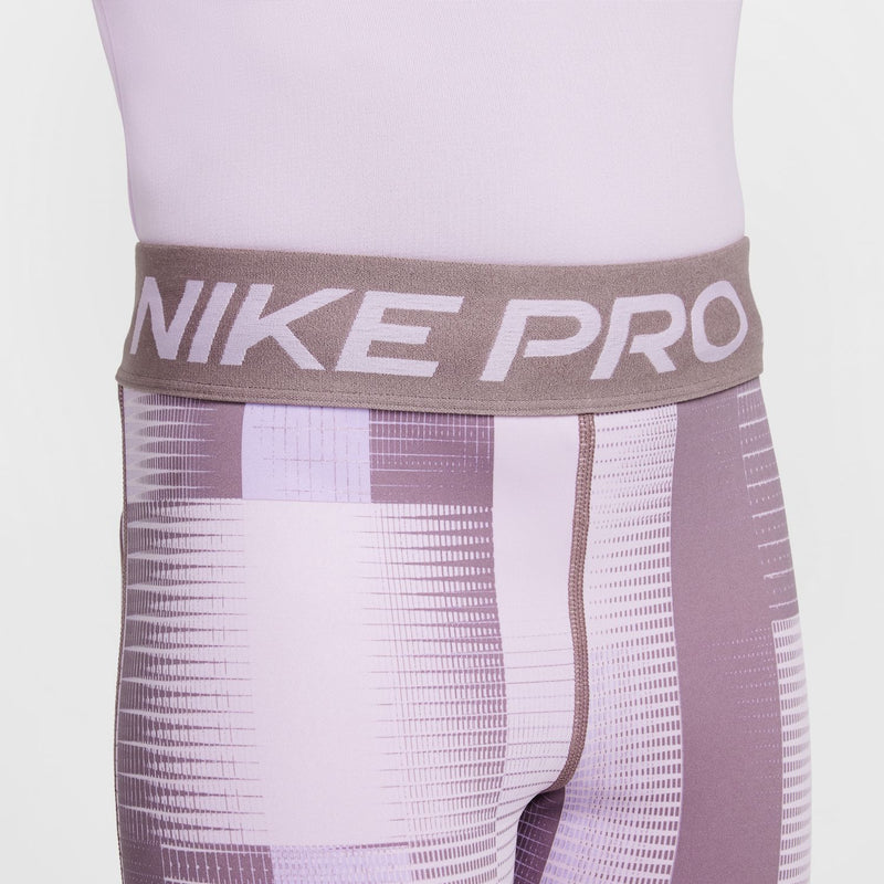 Youth compression shorts waistband detail: taupe “NIKE PRO” on light purple base