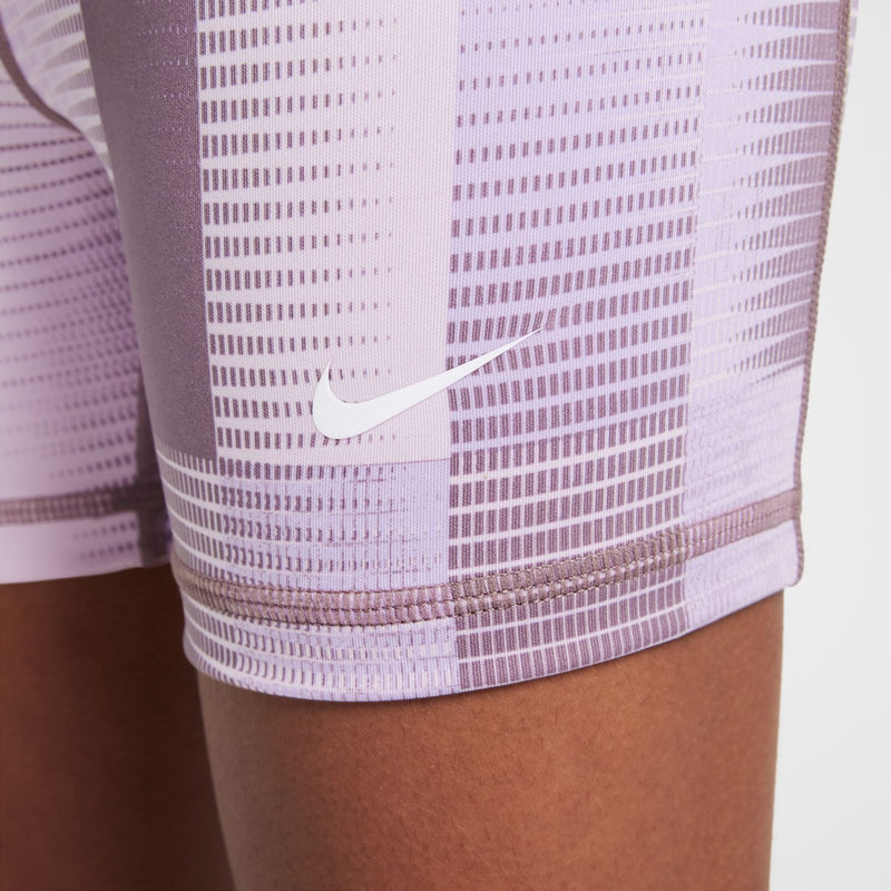Youth compression shorts logo detail: white Nike swoosh on light purple patterned fabric