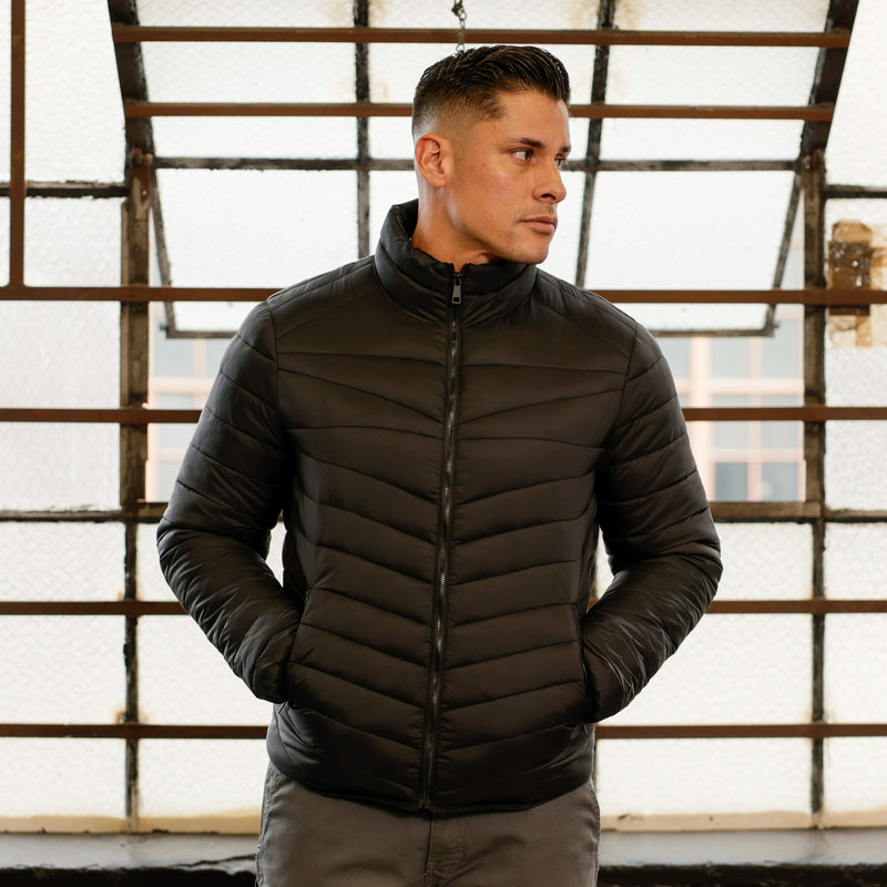 Men's black puffer jacket with stand collar and zip front, quilted stitch lines