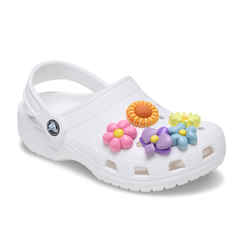 Puffy flower Jibbitz charms on white clog: pink, orange, yellow, purple, and blue flowers