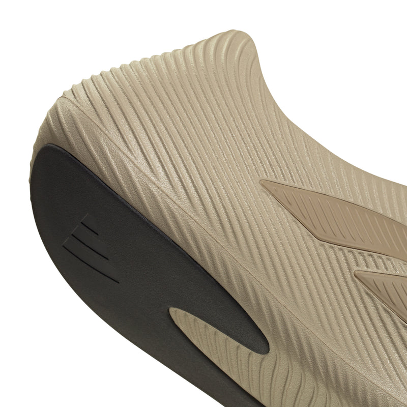 Men's khaki slip-on sneakers, outsole close-up with dark heel and logo marks