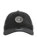Black baseball cap with circular Raiders logo patch on the front, curved brim