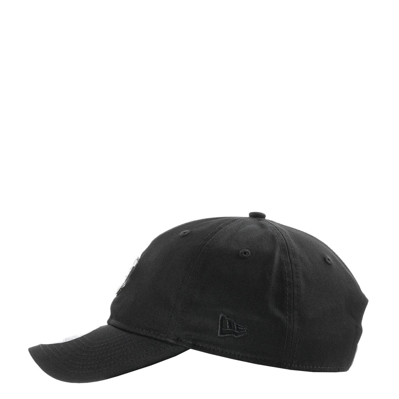 Black baseball cap with small stitched flag emblem on the front panel