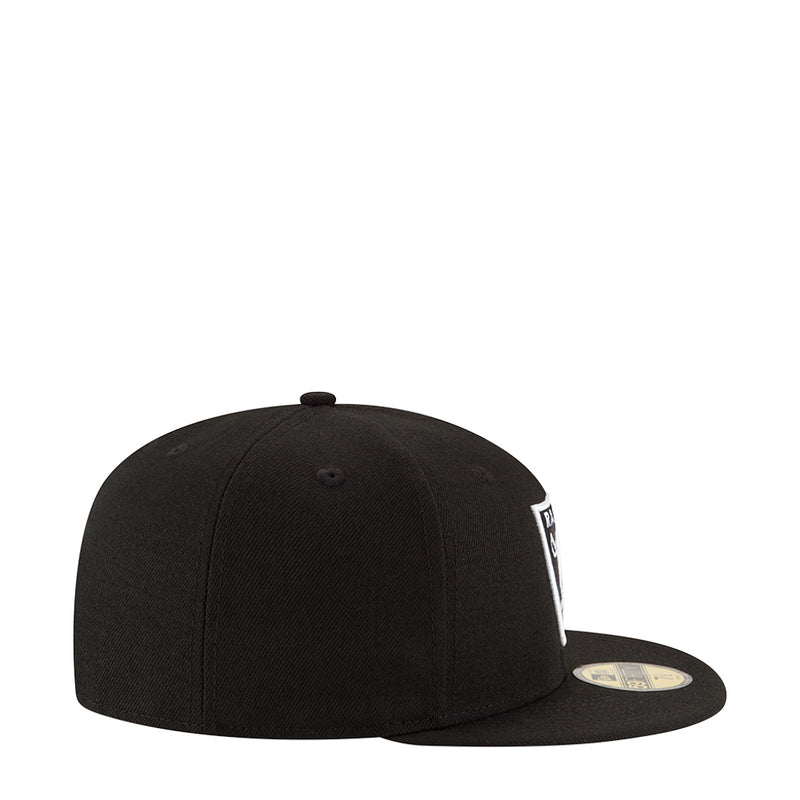Black snapback cap with white side logo patch and curved brim