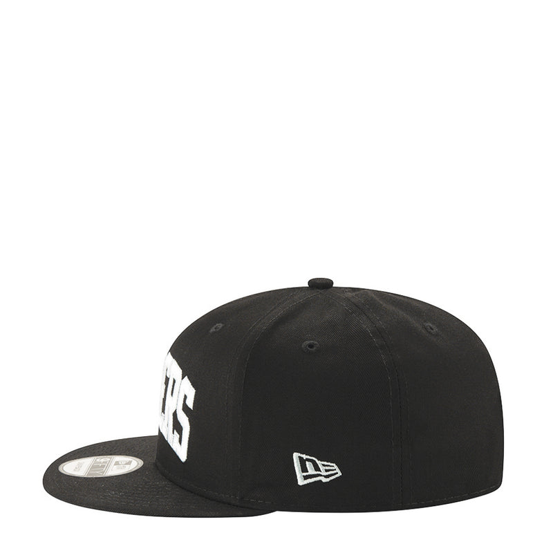 Black baseball cap with white Raiders lettering and New Era flag logo