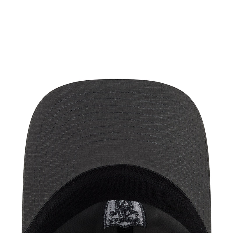 Inner crown of dark gray cap with Raiders logo patch on black sweatband