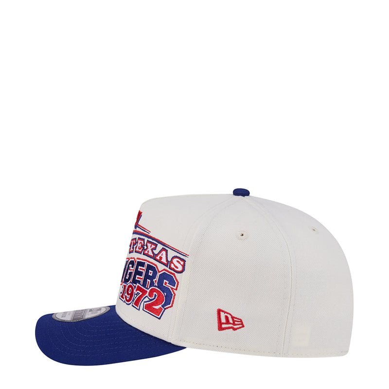 Two-tone A-frame baseball cap with cream crown, navy brim, and front logo detail