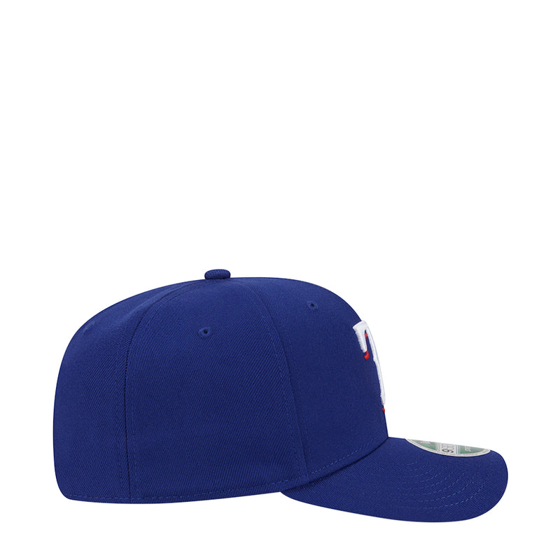Blue baseball cap side view with curved brim and logo patch