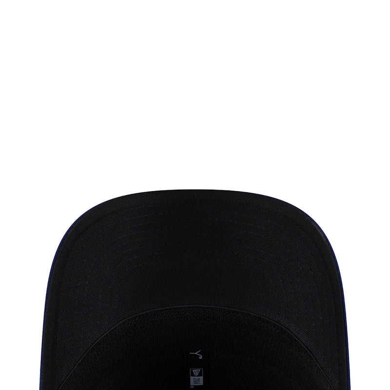 Black baseball cap crown close-up with small interior brand marking