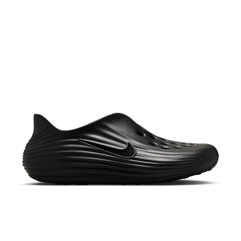 Black slip-on clog with swoosh-style emblem on side and raised wave sole pattern.