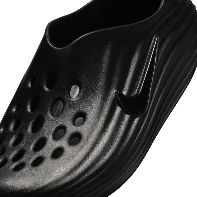 Black clog upper with raised ventilation holes and curved side panel detail.