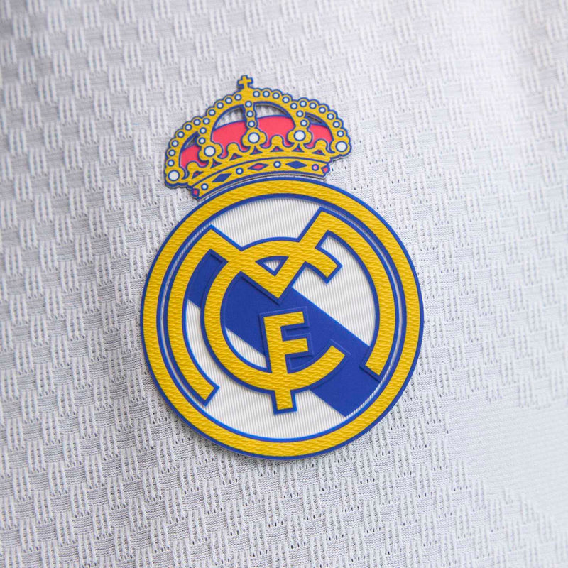 Real Madrid club crest patch with gold crown and blue emblem on jersey