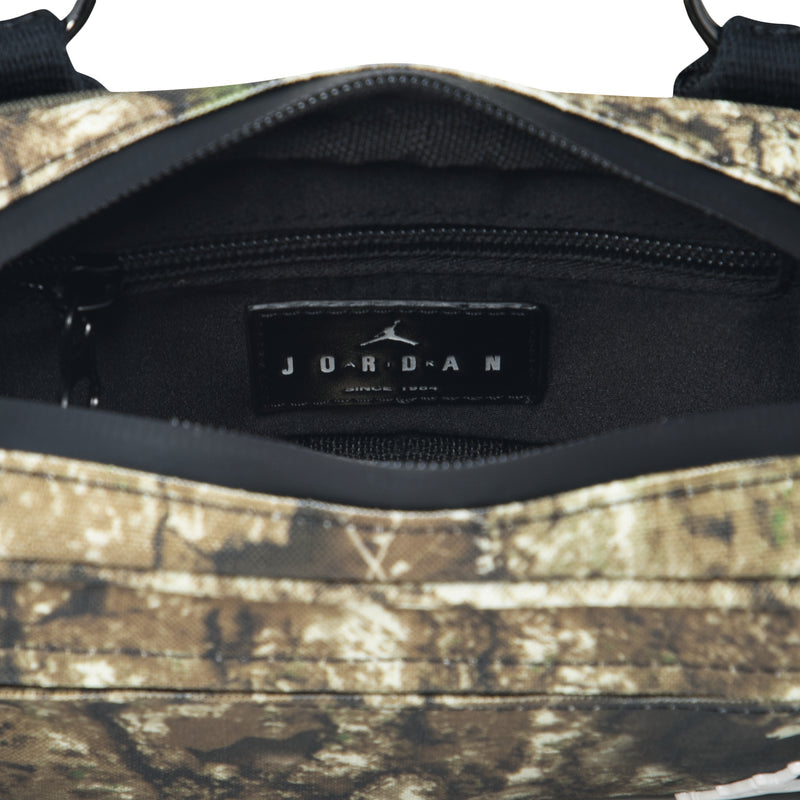 Inside view of olive camo camera bag with black lining and JORDAN logo on zipper