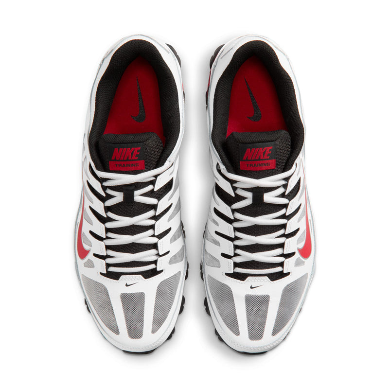 Pair of men's white training shoes with red insoles and NIKE branding on the tongue