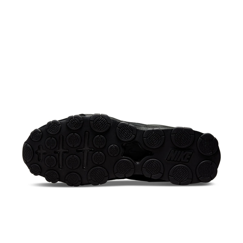 Men's black Nike training shoe outsole with circular traction pods and Nike logo.