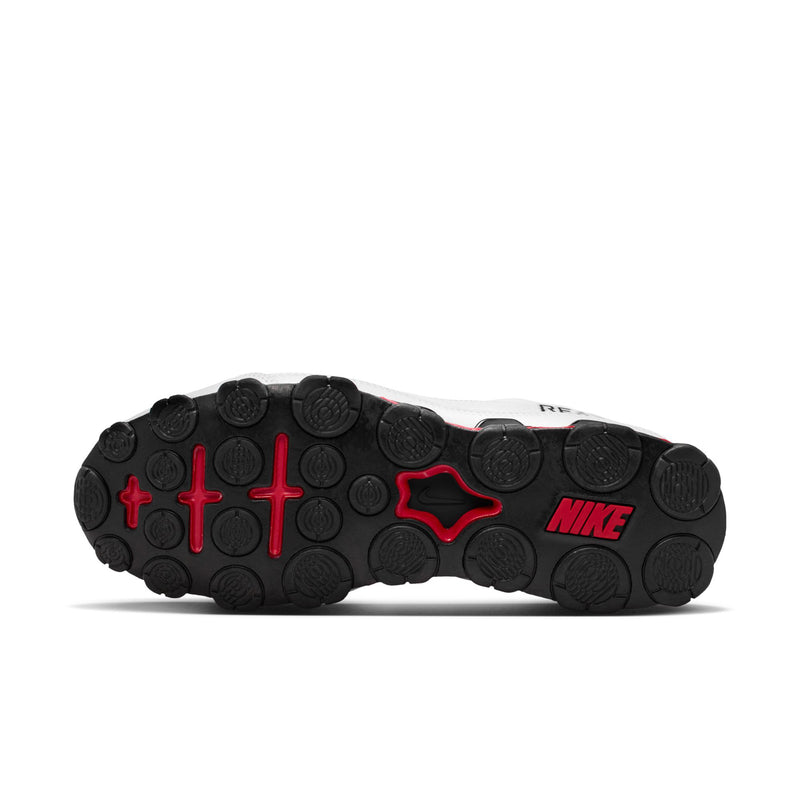 Men's white training shoe outsole with red traction pods and NIKE logo