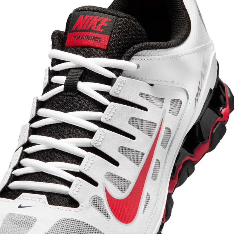 Close-up of men's white laced training shoe with red swoosh and TRAINING label