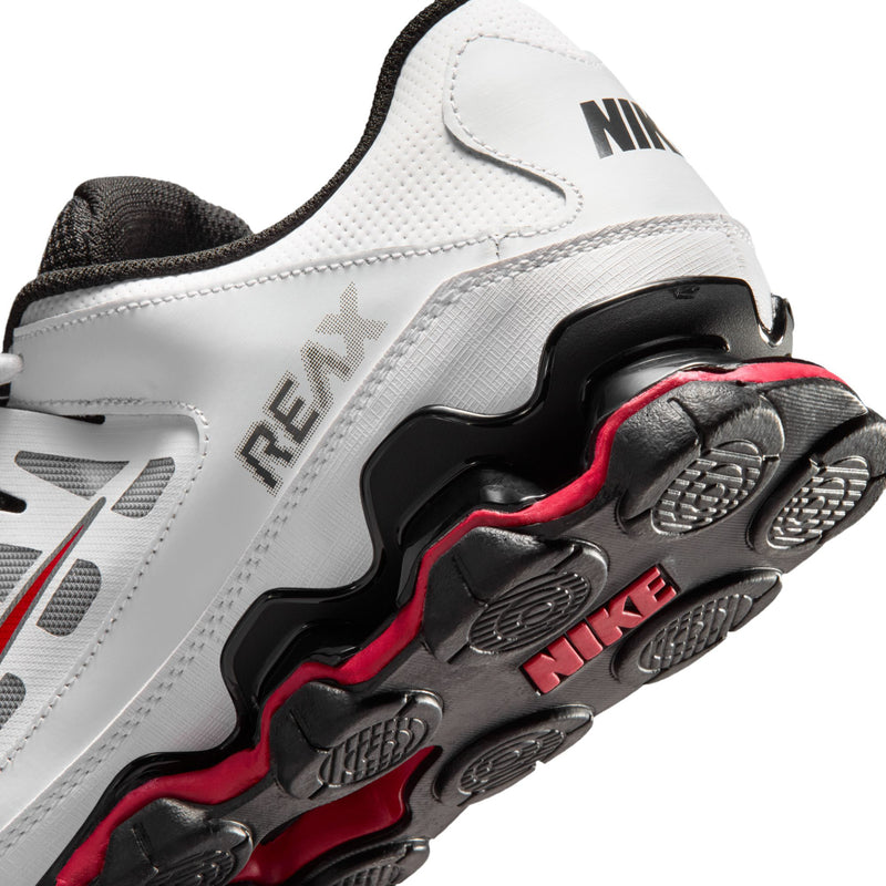 Close-up of men's white training shoe side with REAX text and red-edged outsole