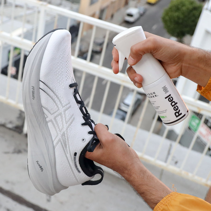 Repel protectant spray applied to a white sneaker toe and laces