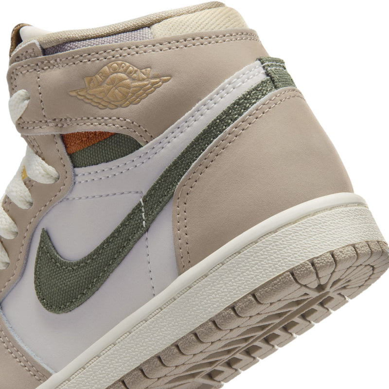Kids high-top sneaker close-up of beige leather, green swoosh, and off-white midsole