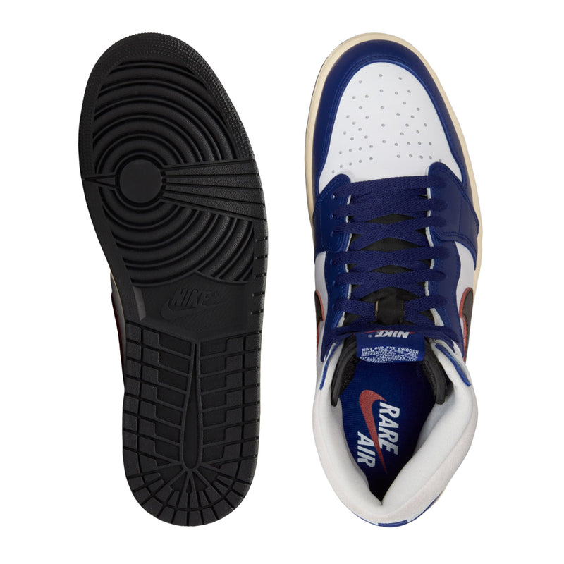 Shoe outsole and inner side, dark rubber tread with blue-and-white upper
