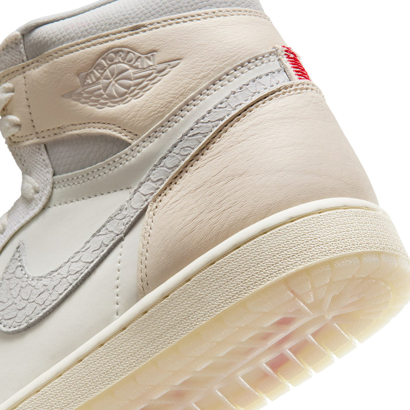 Men's cream high-top sneaker close-up, Air Jordan Wings logo, red accent, gum sole