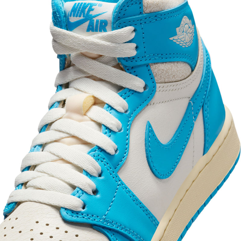 Youth high-top sneaker close-up, blue and white leather with white laces.