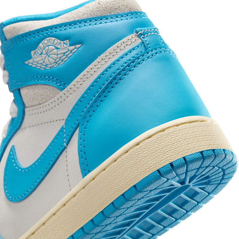 Youth high-top sneaker ankle detail with Air Jordan wing logo in blue and white.