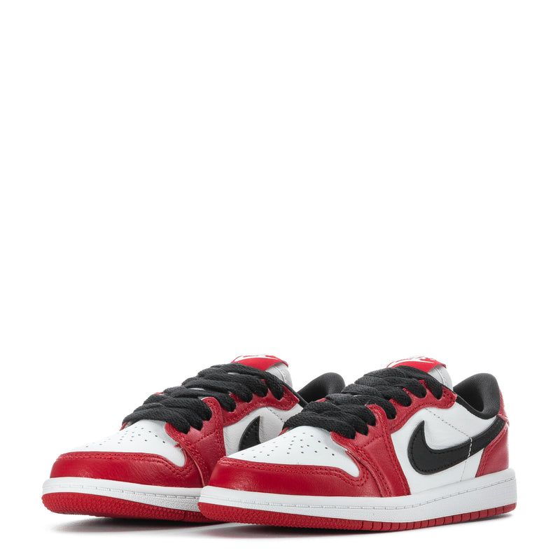 Kids low-top sneakers pair, red and white uppers with black laces and Swoosh