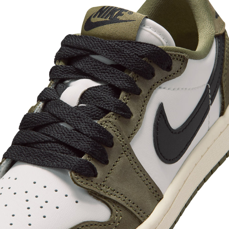 Kids sneaker close-up of olive suede and white leather with black lace and swoosh