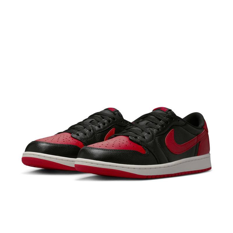 Pair of black and red low-top sneakers with red Nike swooshes and white soles