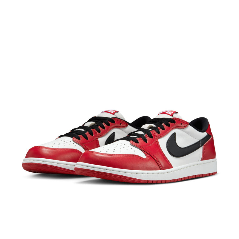 Pair of men's low-top sneakers with red leather panels, white toe, and black swoosh