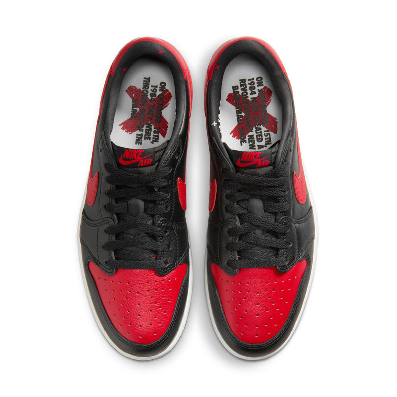 Black and red low-top sneakers, top view showing laces and printed insoles