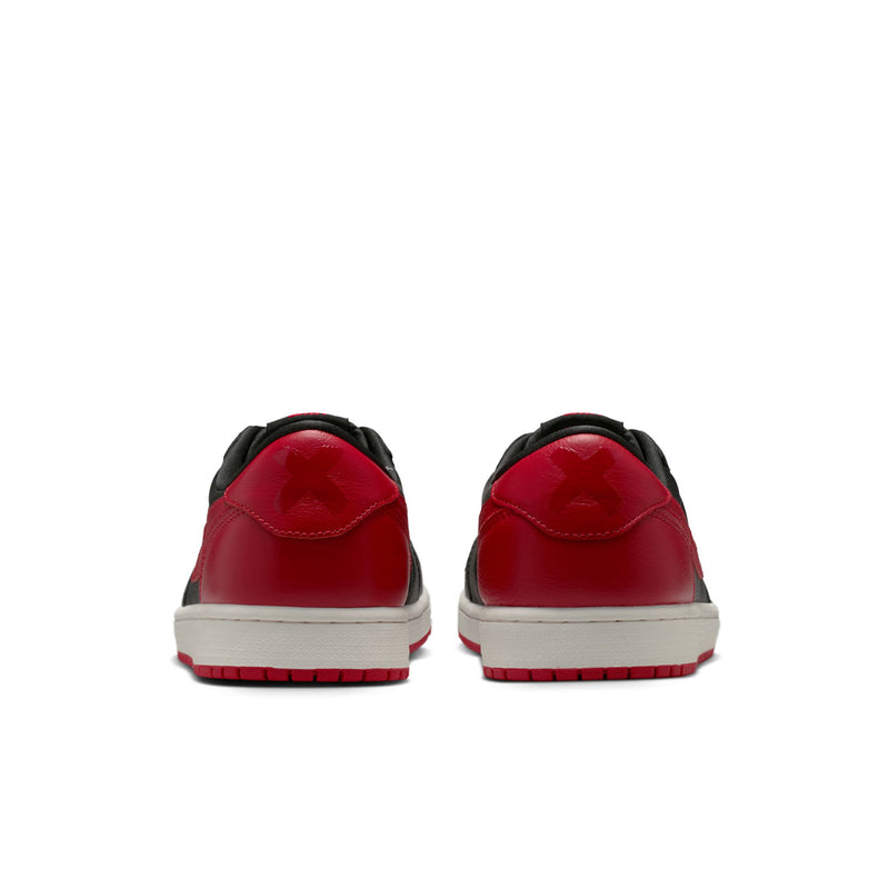 Back view of black and red low-top sneakers with white sole and red heel panels