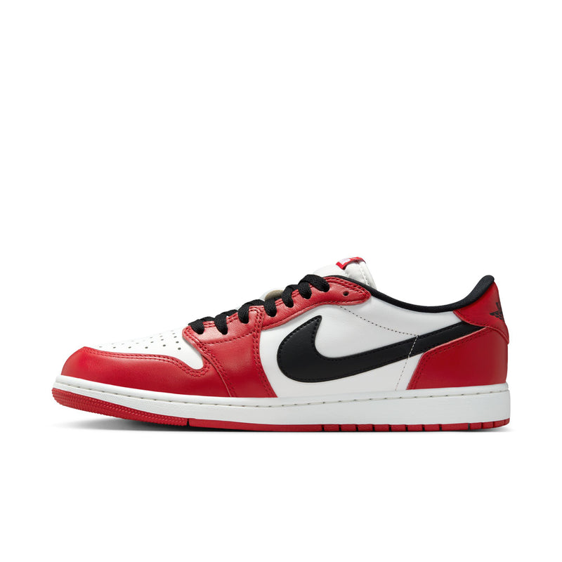 Men's low-top sneakers side view in red and white with black swoosh and black laces