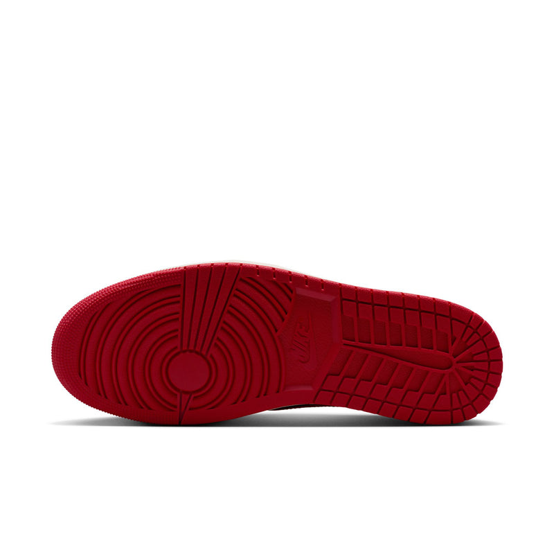 Red rubber outsole with tread pattern under black and red low-top sneakers