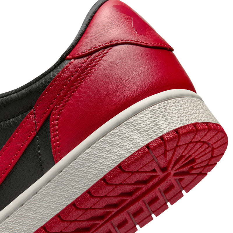 Close-up of red and black low-top sneaker quarter with white outsole edge