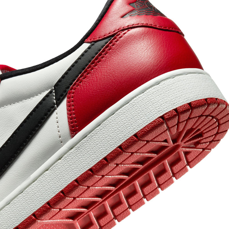 Close-up of red sneaker side and outsole with white midsole and black strap detail