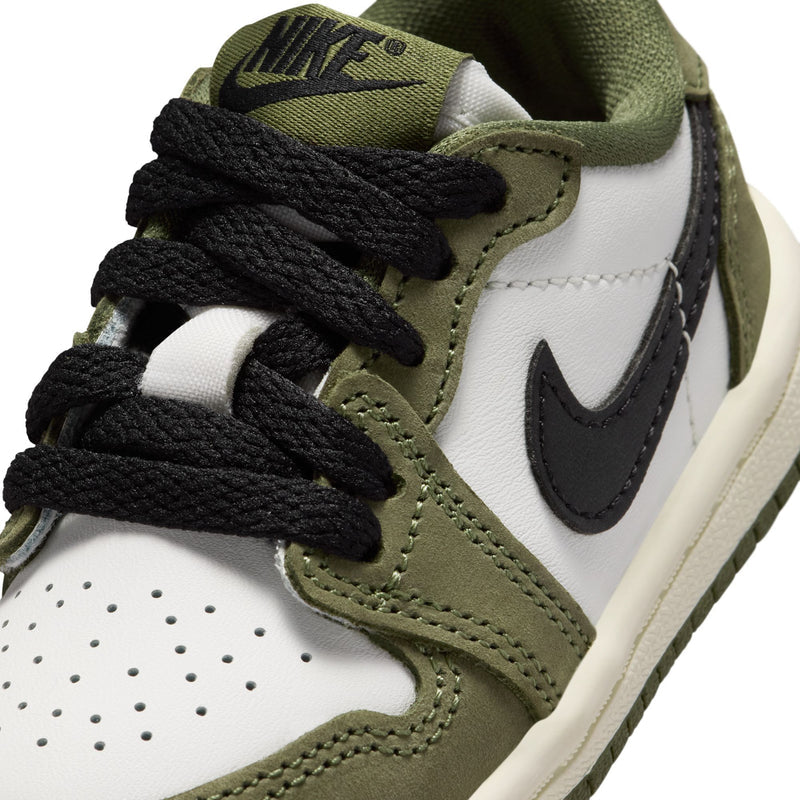 Toddler sneaker close-up showing black laces, black swoosh, olive and white panels