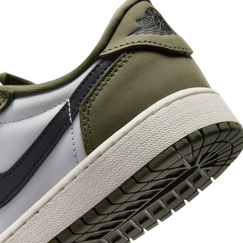 Youth sneaker outsole close-up, olive traction tread with white midsole edge