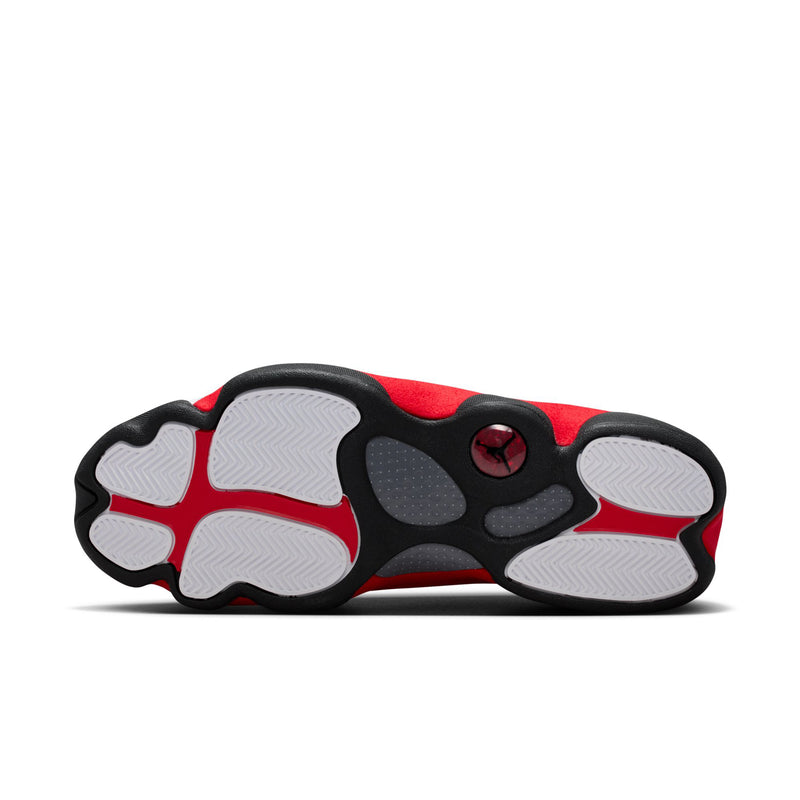 Outsole view of white and red high-top sneakers with textured traction pads