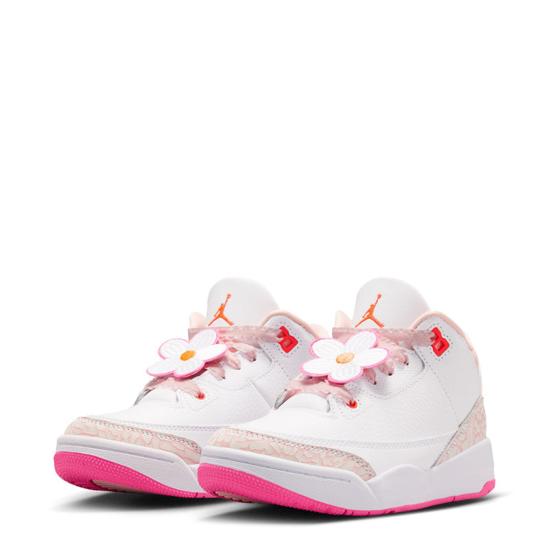 Pair of kids high-top sneakers with white uppers, pink flowers on laces, pink outsole