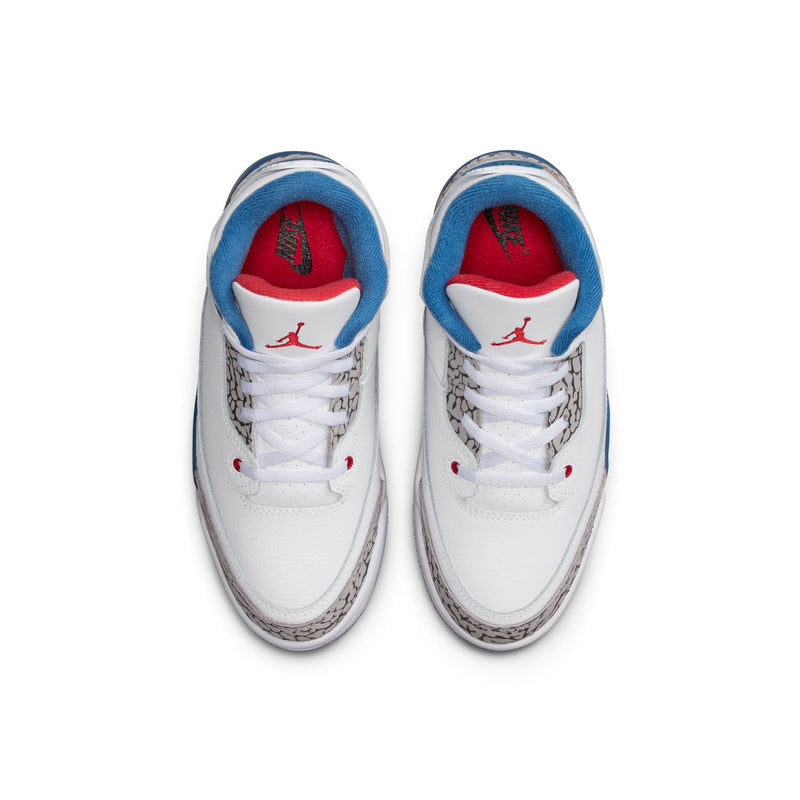 Kids sneakers with white uppers, blue lining, and red Jumpman logos on the tongues.
