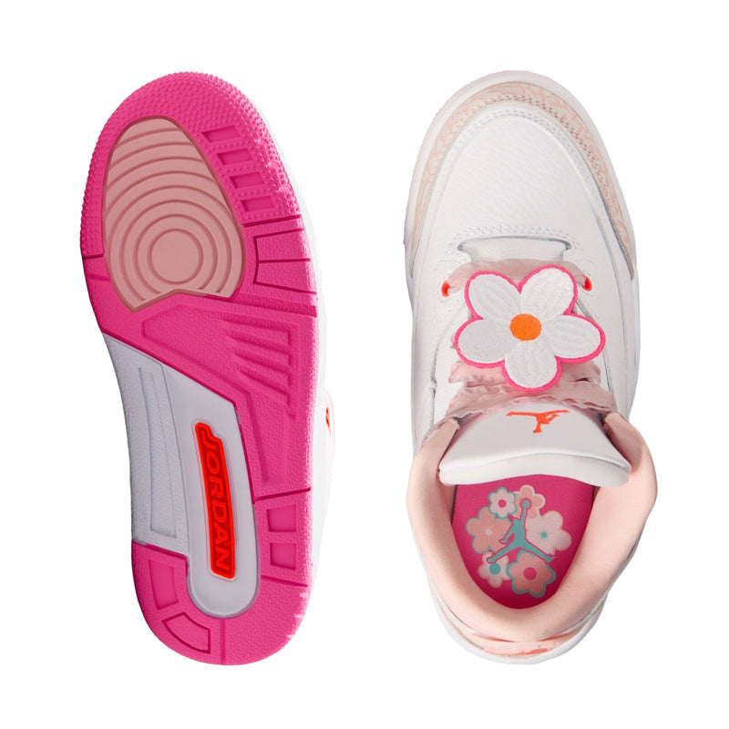 Kids sneaker outsole and insole view, pink tread bottom and pink flower detail inside