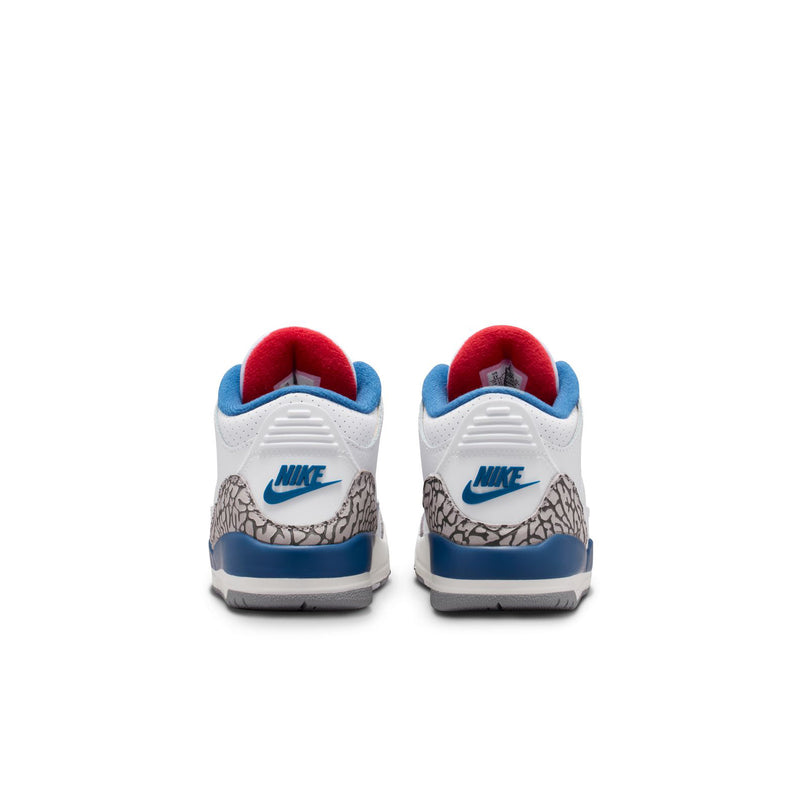 Kids sneakers heel view with red lining, blue Nike logo, and cement grey textured panel.