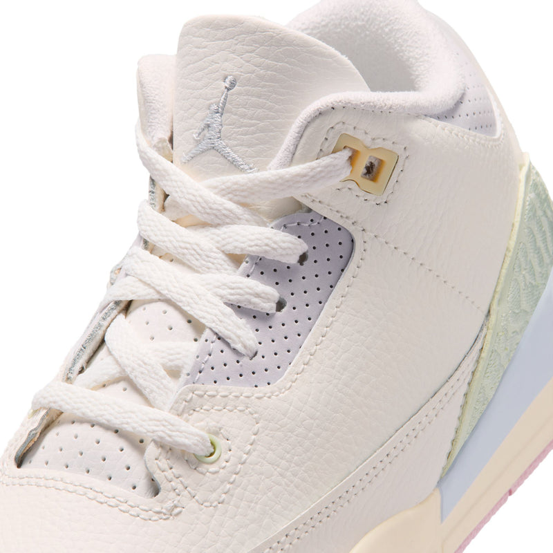 Close-up of Kids' white leather sneakers with laces and light green trim
