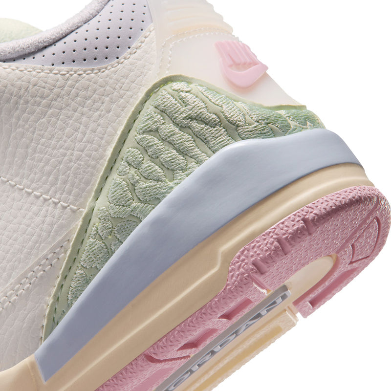 Close-up of Kids' sneaker side panel: textured mint green with pastel sole