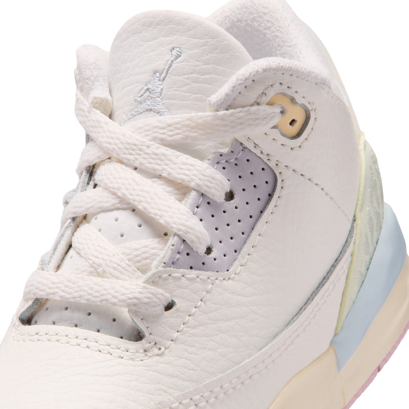 Toddler white sneaker close-up with lace-up, perforations, and Wings logo